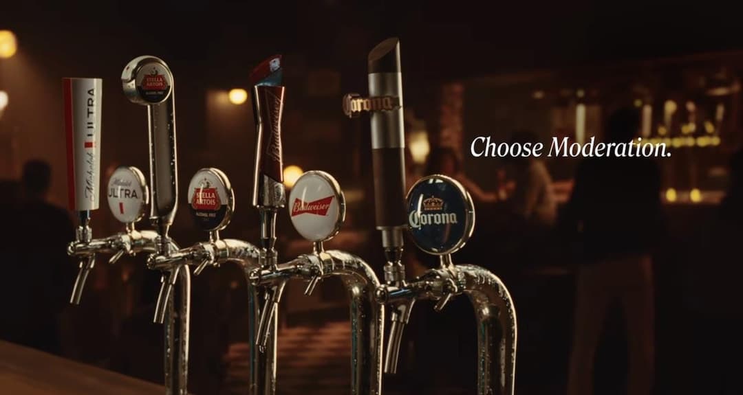 The image shows a bar with a row of beer taps, each featuring a different beer brand. The taps are arranged in a row, with the first tap on the left displaying a red and white label for "Molson Ultra". The second tap is labeled "Stella Artois", the third is labeled "Budweiser", and the fourth is labeled "Corona". The f