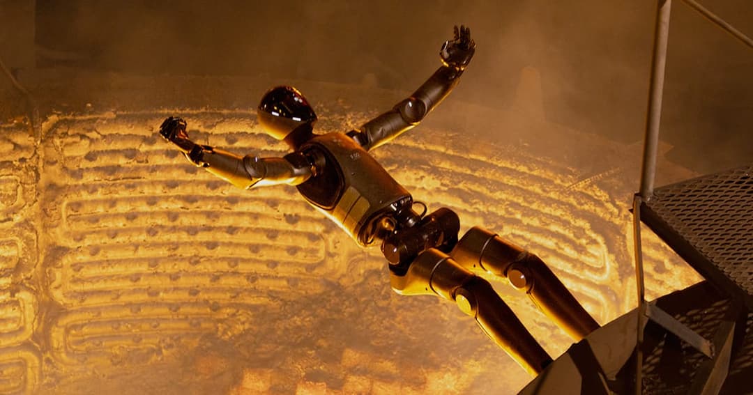 The image shows a robot with a dark, possibly black, head and arms, and a dark, possibly black, body, suspended in mid-air above a large, circular furnace. The robot's arms are outstretched, and its legs are bent at the knees, suggesting a state of motion. The furnace is emitting a bright orange glow, and the backgroun