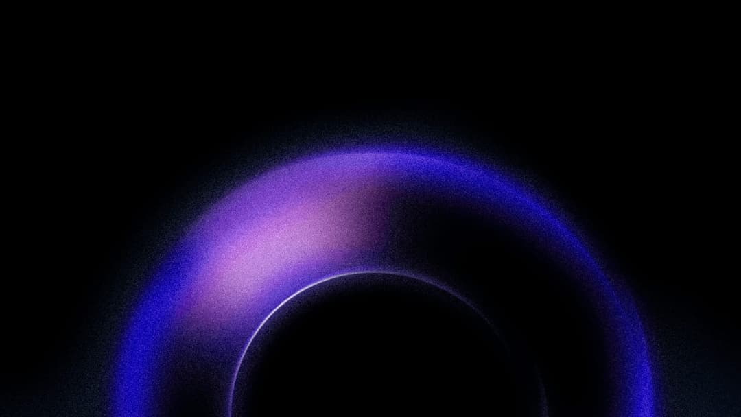 The image presents a captivating scene of a black hole, a region of space where gravity is so strong that not even light can escape. The black hole is a deep, dark blue, and its surface is speckled with a grainy texture, giving it a slightly rough appearance. The black hole is surrounded by a vibrant purple glow, which