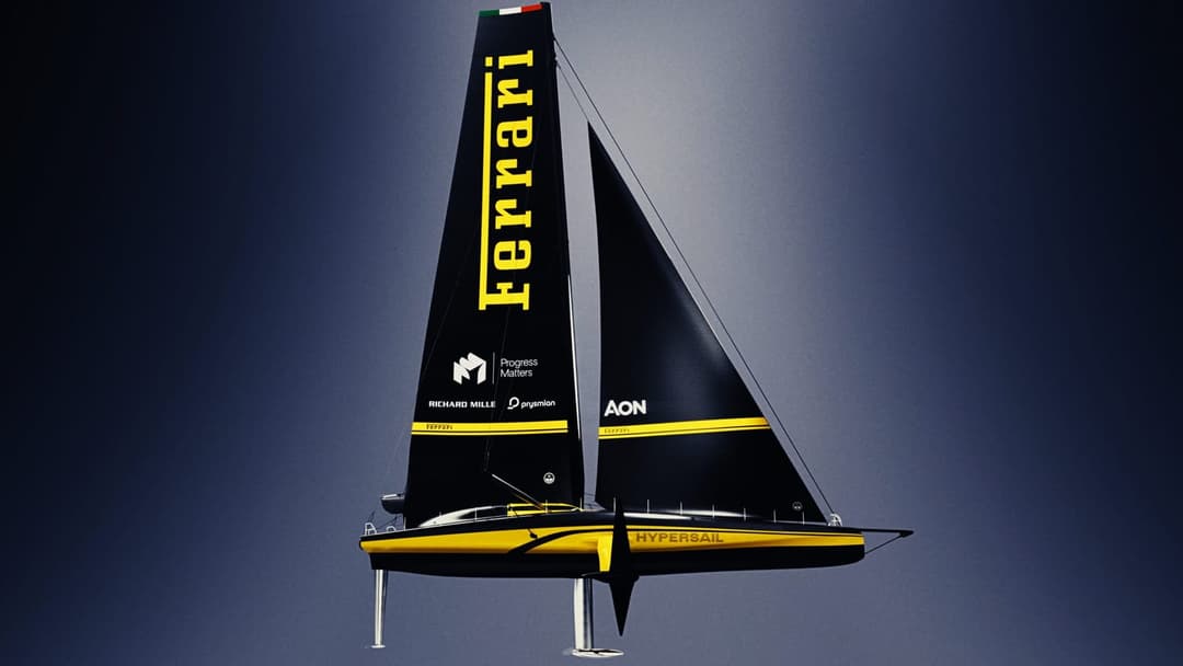 The image depicts a sailboat named "Ferrari" soaring through the sky. The boat is painted in a striking combination of black and yellow, with the name "Ferrari" prominently displayed on the sail. The hull of the boat is primarily black with a yellow stripe running along its side. The sail is black with a yellow stripe