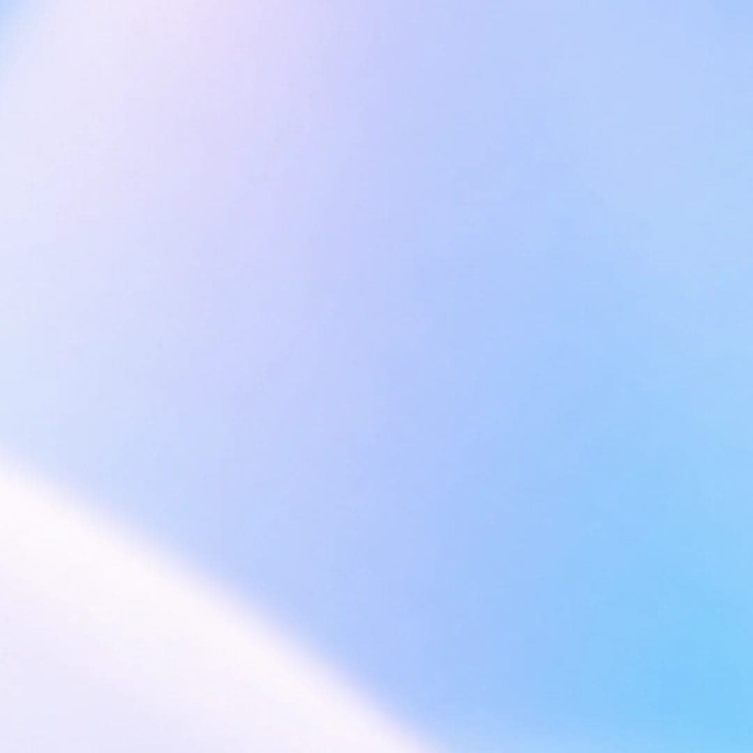 The image presents a serene scene of a blue sky meeting a white horizon. The sky, a gradient of blue and white, stretches out to meet the horizon, which is a soft white. The image is devoid of any text or discernible objects, and the relative positions of the sky and horizon remain constant. The image is a simple, abst