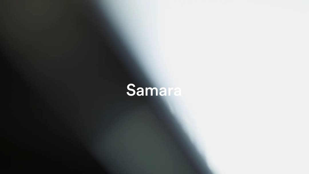 The image presents a close-up view of a textured surface, possibly a piece of fabric or a similar material. The surface is predominantly black, with a gradient effect that transitions from a darker shade at the top left to a lighter shade at the bottom right. The text "Samara" is written in white, centrally positioned