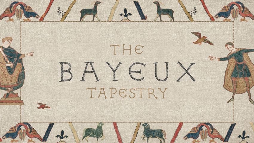 The image presents a tapestry with a beige background. The tapestry is framed by a border composed of stylized branches and leaves in shades of red, brown, and beige. The border is bordered by a cream/off-white color. The central focus of the tapestry is the text "THE BAYEUX TAPESTRY" written in a serif font. On either