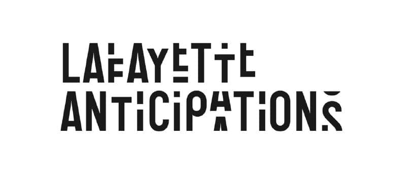 The image presents a striking black and white logo. Dominating the center of the image is the text "LA FAYETTE ANTICIPATION'S", written in a bold, sans-serif font. The text is arranged in two lines, with "LA FAYETTE" on the top line and "ANTICIPATION'S" on the bottom line. The text is capitalized, creating a sense of p