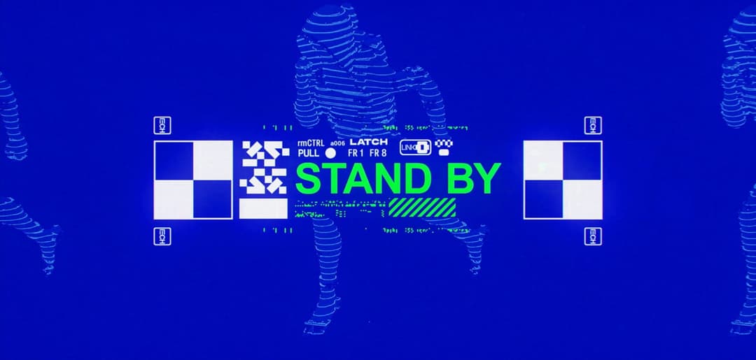 The image presents a digital interface with a blue background and a grid of white squares with black and white checkerboard patterns. The word "STAND BY" is prominently displayed in green text, with "STAND BY" in white and "STAND" in green. The interface also includes a small, light blue rectangle with the text "LATCH"