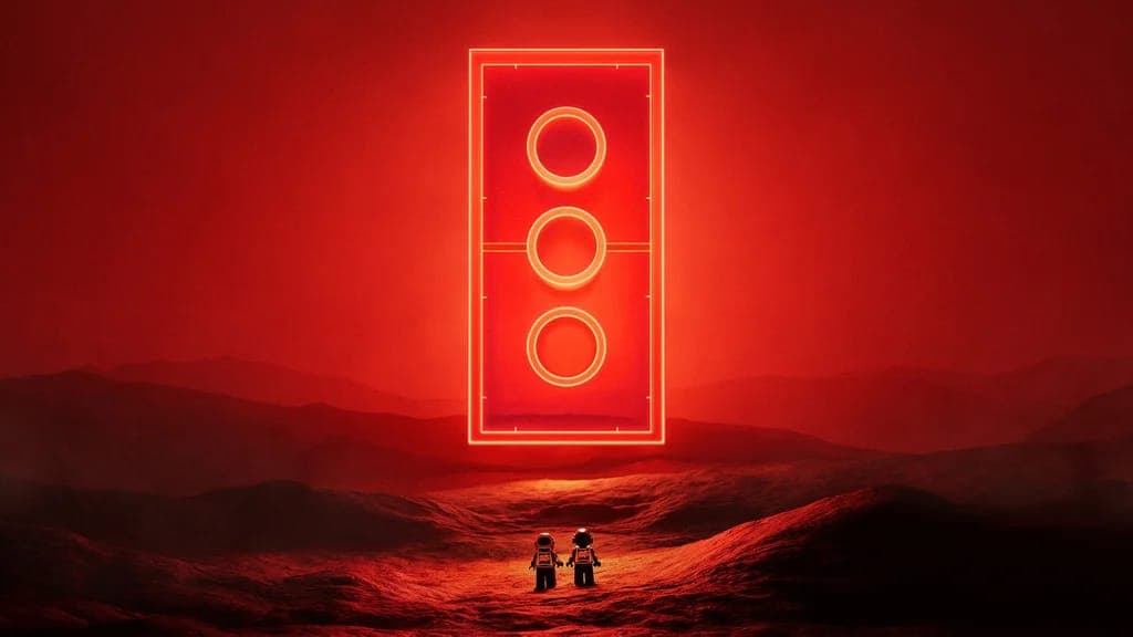 Two small LEGO-style astronaut figures stand on a red, rocky landscape beneath a large glowing red neon rectangle with three circles. No text or brand is visible.