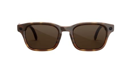 The image presents a pair of tortoiseshell sunglasses with a brown frame and dark brown lenses. The sunglasses have a slightly curved shape, with the top right corner pointing towards the top left corner. The lenses are rectangular and appear to be dark brown. The sunglasses are set against a solid green background.