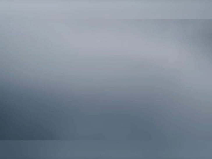 The image presents a digital illustration featuring a gradient background that transitions from a darker blue at the top to a lighter blue at the bottom. The gradient is smooth and continuous, creating a sense of depth and dimension. The image is devoid of any discernible objects, text, or actions, and is presented in