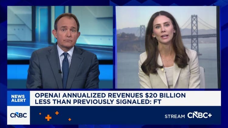 The image is a screenshot of a CNN news broadcast. The broadcast is divided into two sections, with the left section featuring a man in a dark suit and tie, and the right section featuring a woman in a light-colored blazer. The man is seated at a desk, while the woman is standing behind a desk. The news anchor is deliv
