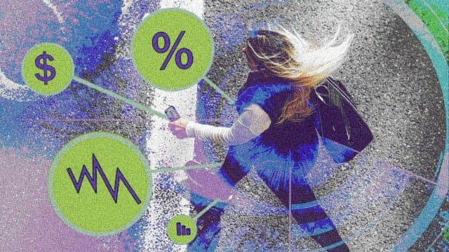 The image shows a woman walking on a street, her hair blowing in the wind. She is wearing a blue jacket and black pants, and is carrying a black purse. She is also wearing a white long-sleeved shirt underneath her jacket. The street is gray, and the background is a mix of purple and blue. The image is overlaid with a s