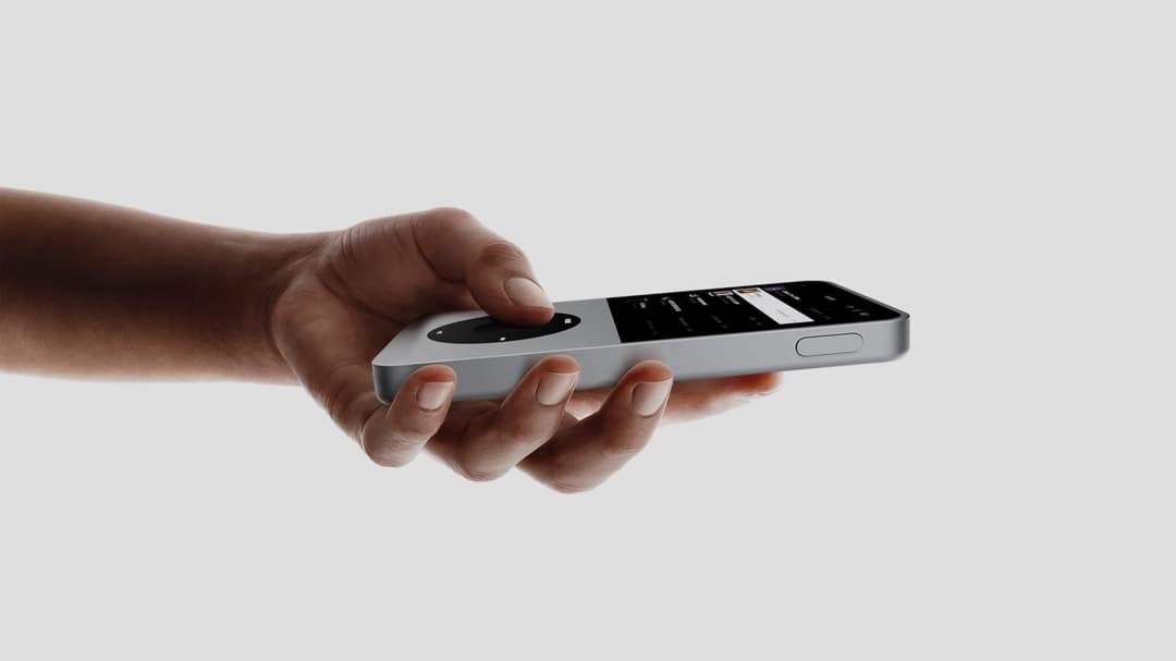 The image shows a hand holding a silver iPod Touch. The iPod Touch has a sleek, minimalist design with a silver body and a black screen. The screen displays a music player interface with a few songs visible. The hand is positioned in the center of the image, with the iPod Touch held horizontally. The background is a pl