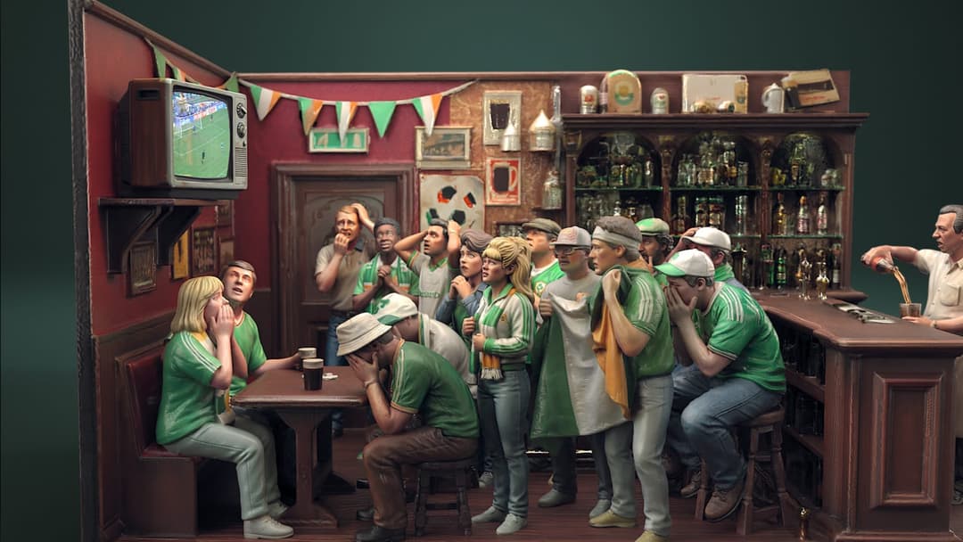 The image depicts a lively scene in a pub, with a group of people gathered around a wooden bar. The pub has a dark red or maroon wall and a dark brown wooden counter. A television screen is mounted on the wall, displaying a soccer game. The people are dressed in green and white, and some are wearing hats, suggesting a