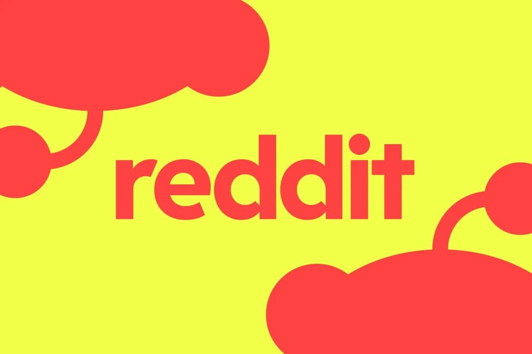 The image features a vibrant yellow background with the word "reddit" written in bold, red letters. The letters are slightly tilted to the right. On the left side of the image, there are two red, cloud-like shapes, one on the top and one on the bottom, with a small, red dot in the center of the top one. On the right si