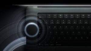 A close-up of a dark laptop keyboard with a glowing circular dial graphic and light trails on the left side.