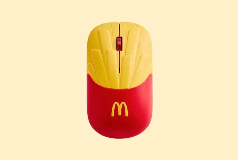 A front view of a McDonald's fries-shaped mouse on a pale yellow background. The golden arches logo is visible on the red lower section.