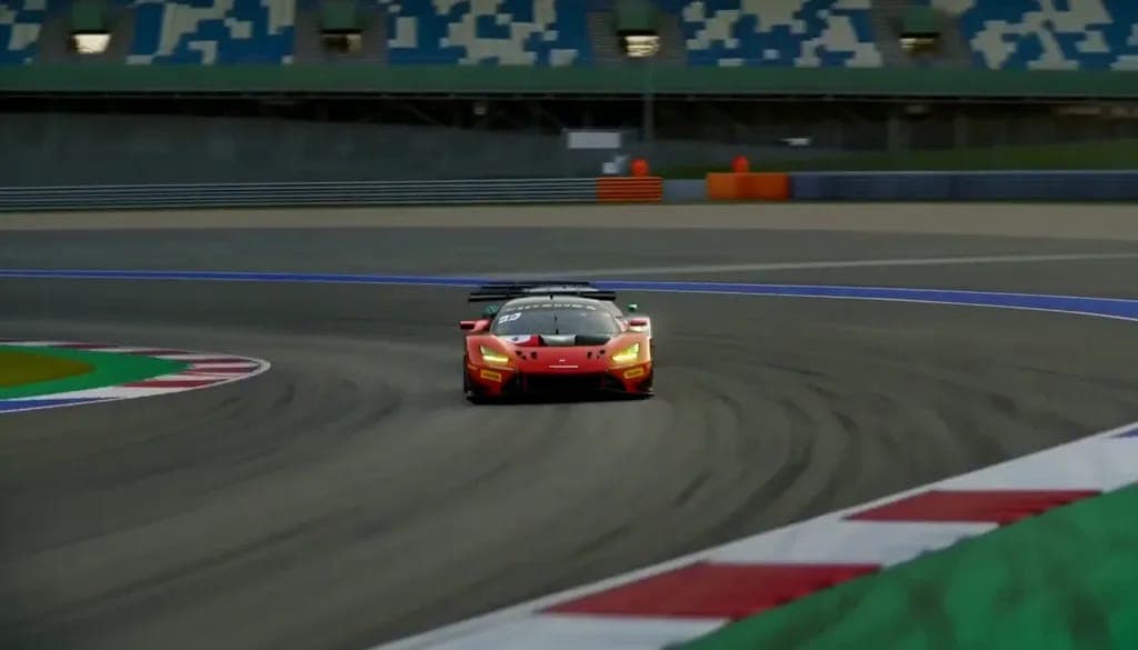 The image captures a vibrant scene from a racing video game, featuring a red McLaren race car in full motion on a gray track. The car is positioned in the center of the frame, moving towards the right side of the image. The track is marked with red and white curbs, and the background reveals a stadium with blue and whi