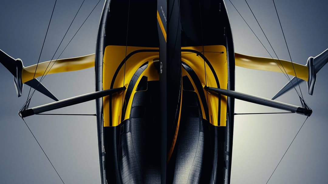 The image shows a black and yellow aircraft, possibly a drone or a modified aircraft, viewed from a low angle. The aircraft has a sleek, streamlined design with a black body and a yellow wing-like structure on the sides. The underside of the aircraft is primarily black with yellow accents. The aircraft is equipped with