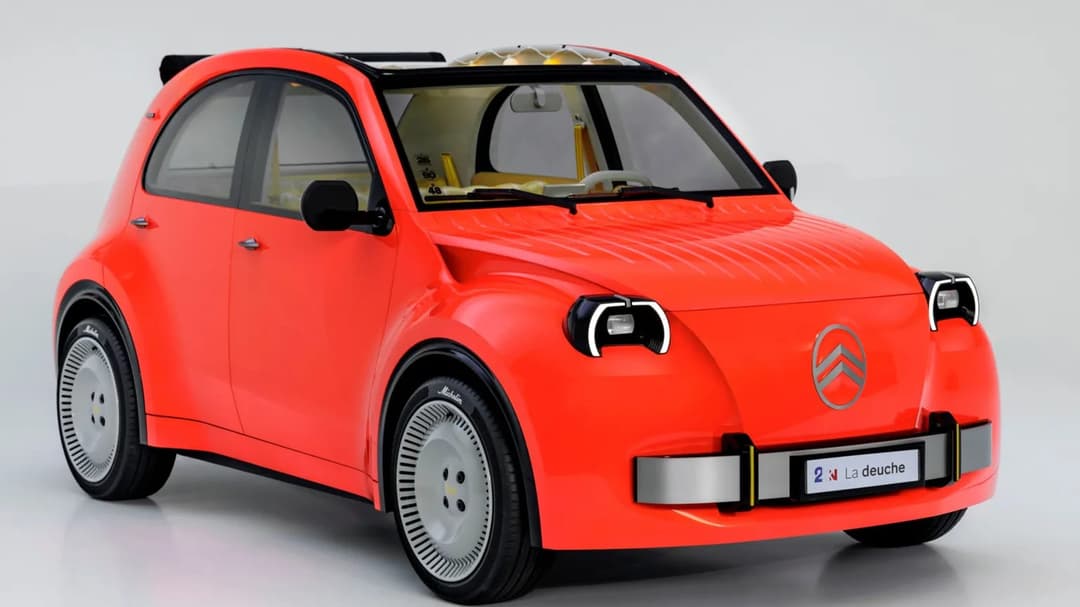 The image shows a vibrant red car with a sleek, modern design. The car features a black roof and a silver front bumper, giving it a sporty appearance. The car is positioned on a white surface, with a slight reflection visible beneath it. The car has a unique design, with a large front grille and a smaller rear grille,