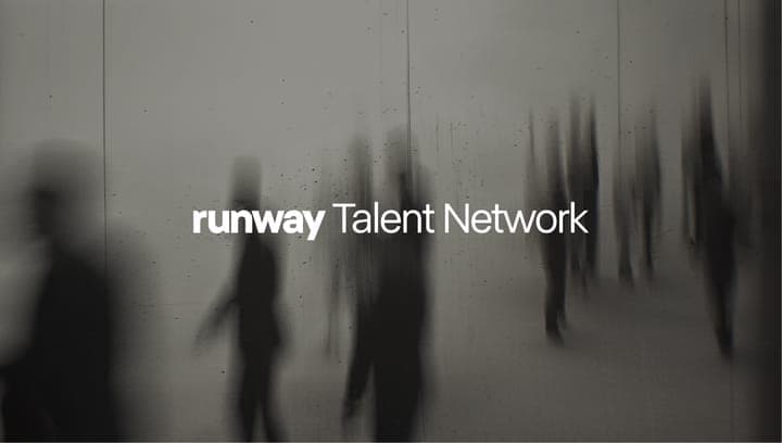 The image is a black and white photograph of a runway, with the words "runway Talent Network" displayed in white text in the center. The runway is filled with blurred figures, likely people, walking in various directions. The background is a light gray or off-white color, and the overall impression is one of a busy, po