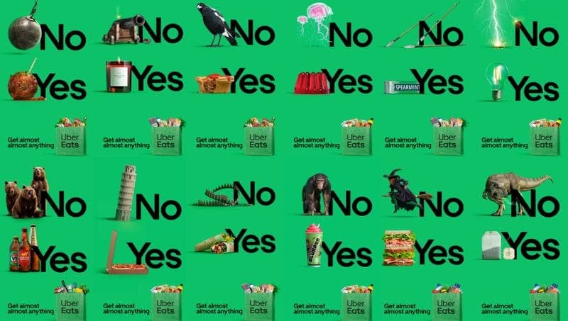 The image presents a vibrant advertisement for Uber Eats, featuring a collage of various food items and objects arranged in a grid pattern against a green background. The objects include a cannon, a bird, a jellyfish, a lightbulb, a pepper shaker, a sandwich, a hot dog, a lobster, a hot dog, a pizza, a hot dog, a hot d