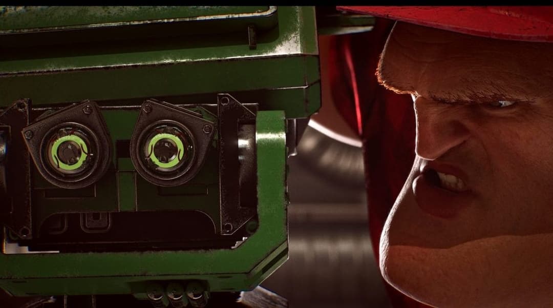 The image shows a close-up of a man's face, with a red hat and a stern expression. His eyes are narrowed, and his mouth is slightly open, giving him a serious or angry look. The man is positioned in front of a green machine, which appears to be a piece of industrial equipment. The machine has two large, round, green co