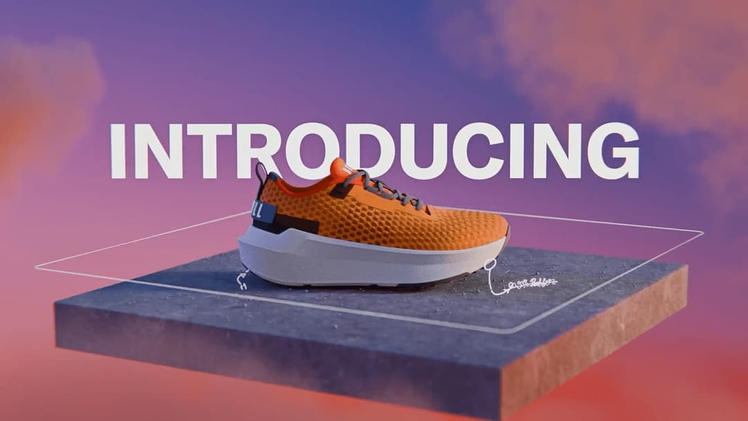 The image presents a single orange sneaker with a white sole, positioned on a gray platform. The sneaker has a textured orange upper and black accents, and features a white laces. The platform is set against a backdrop of a gradient sky, transitioning from purple at the top to pink at the bottom. The word "INTRODUCING"