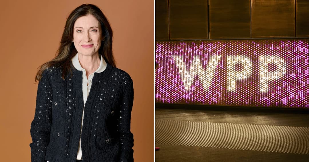 A smiling woman with long dark hair, wearing a black textured jacket over a white collared shirt, stands against a tan backdrop. On the right, a perforated wall lit with pink and white light shows the partly obscured letters "WPP".