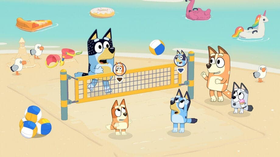 The image depicts a lively beach scene with a blue heeler dog and a blue heeler dog participating in a beach volleyball game. The blue heeler dog is on the left side of the net, while the blue heeler dog on the right is attempting to block the ball. The volleyball is in mid-air, and the blue heeler dog is reaching out